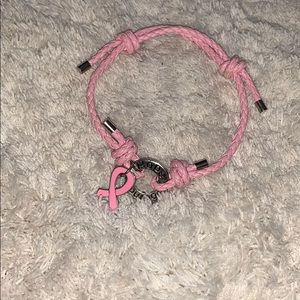 A pink and silver cancer courage braclet